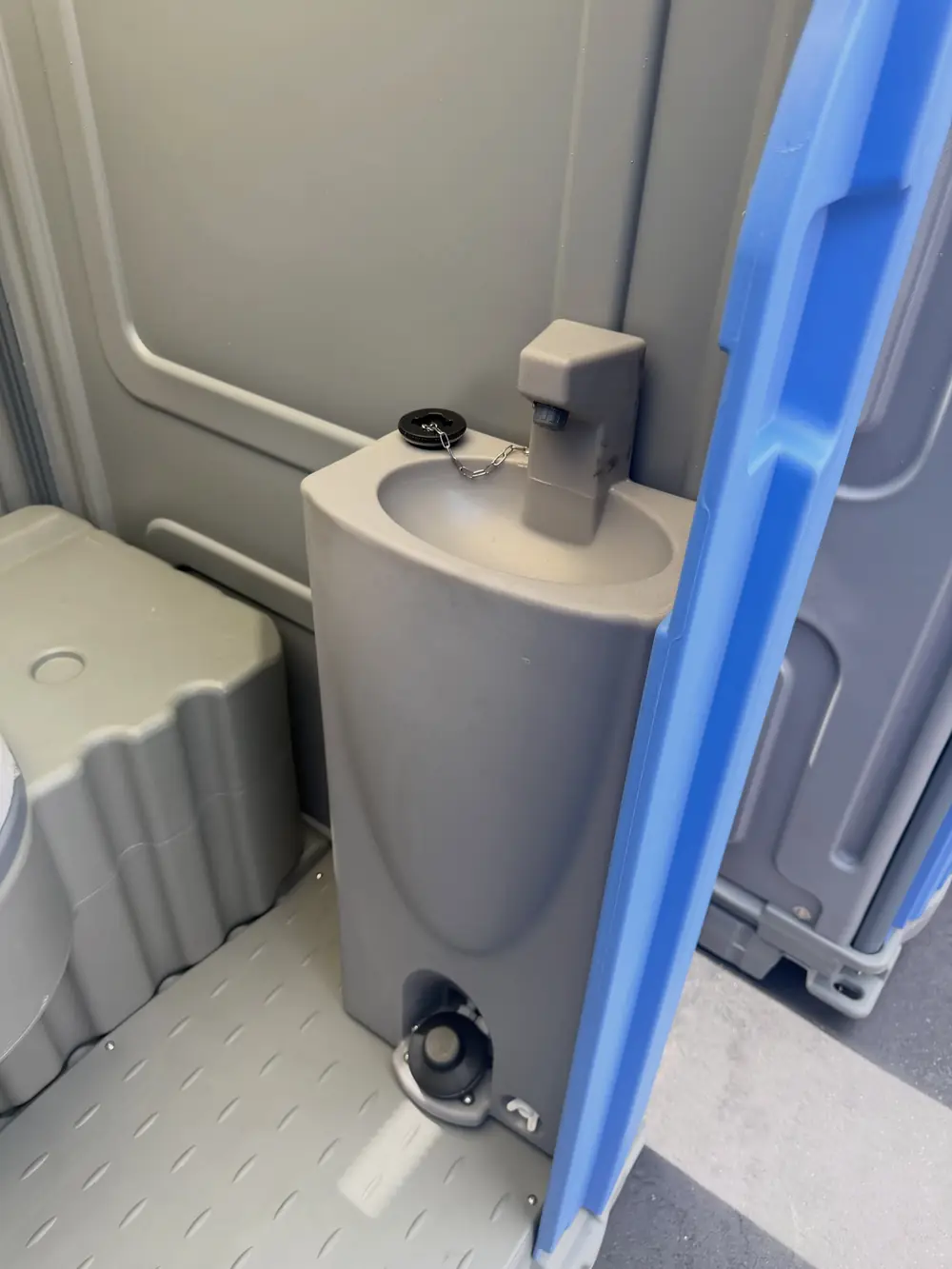 Clean porta potty interior with urinal after service